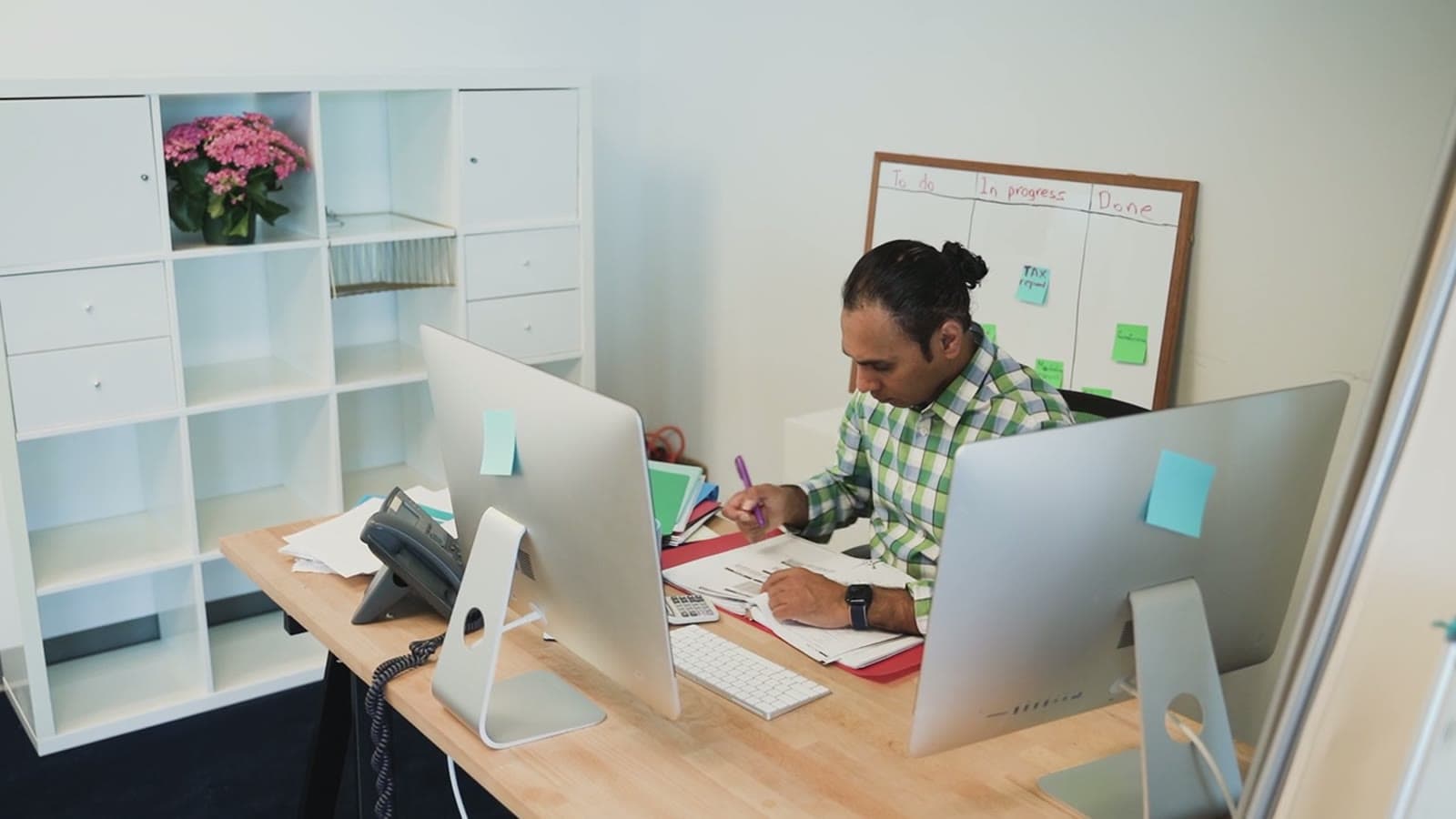 A Company Secretary working through client files at his desk